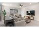 Comfortable living room with a large sectional sofa, a media center, and access to a screened patio, ideal for relaxation at 7180 Oakmoss Loop, Davenport, FL 33837