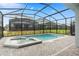 Screened pool area with a built-in hot tub, offering a relaxing outdoor space for homeowners at 7180 Oakmoss Loop, Davenport, FL 33837