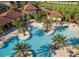 Stunning aerial view of the community pool with lush landscaping and inviting lounge areas at 7180 Oakmoss Loop, Davenport, FL 33837
