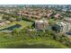 Majestic aerial view shows residential building nestled among trees with lake and landscaping at 7508 Toscana Blvd # 123, Orlando, FL 32819