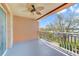 Relaxing outdoor balcony area with ceiling fan and wrought iron railing offering a tranquil view at 7508 Toscana Blvd # 123, Orlando, FL 32819