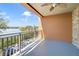 Serene balcony area with ceiling fan and decorative railing offering a captivating lake view at 7508 Toscana Blvd # 123, Orlando, FL 32819