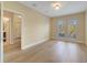 Bright bedroom with hardwood floors and two windows providing natural light at 7508 Toscana Blvd # 123, Orlando, FL 32819
