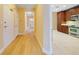 Hallway leading to a kitchen featuring stainless steel appliances and wood cabinets at 7508 Toscana Blvd # 123, Orlando, FL 32819