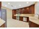Spacious kitchen with stainless appliances, wood cabinets, and tile flooring at 7508 Toscana Blvd # 123, Orlando, FL 32819
