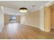 Bright living room with light walls, modern light fixture, and beautiful lake views at 7508 Toscana Blvd # 123, Orlando, FL 32819