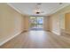 Open living room featuring light walls, fan and sliding doors leading to a deck at 7508 Toscana Blvd # 123, Orlando, FL 32819