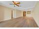 Open-concept living room with fan and view of the kitchen pass-through at 7508 Toscana Blvd # 123, Orlando, FL 32819