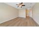 Spacious main bedroom with ceiling fan, light walls, and ensuite bathroom at 7508 Toscana Blvd # 123, Orlando, FL 32819