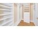 Walk-in closet featuring custom shelving and storage at 7508 Toscana Blvd # 123, Orlando, FL 32819