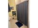 Small bathroom with neutral tiles and blue shower curtain at 8124 Claire Ann Dr # 303, Orlando, FL 32825