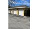 Row of garages with white doors and yellow stucco walls at 8124 Claire Ann Dr # 303, Orlando, FL 32825