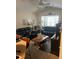 The living room has vaulted ceilings, neutral walls, and black leather couches at 8124 Claire Ann Dr # 303, Orlando, FL 32825