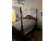Main bedroom showcasing a wooden bed frame and decorative leaf art on the wall at 8124 Claire Ann Dr # 303, Orlando, FL 32825