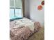 Bedroom featuring a large window with blinds and neutral walls and carpet at 860 N Orange Ave # 318, Orlando, FL 32801