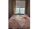 Bright bedroom featuring natural light from the window and floral patterned bedding at 860 N Orange Ave # 318, Orlando, FL 32801
