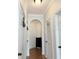 Hallway with arched entrance, hardwood flooring, and white doors at 860 N Orange Ave # 318, Orlando, FL 32801