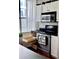 Kitchen featuring stainless steel oven, microwave, and white cabinets for storage at 860 N Orange Ave # 318, Orlando, FL 32801