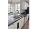 Bright kitchen features large windows, white cabinets and a stainless steel dishwasher at 860 N Orange Ave # 318, Orlando, FL 32801