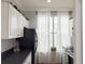 Modern kitchen with black countertop, white cabinets and stainless steel appliances at 860 N Orange Ave # 318, Orlando, FL 32801