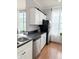 Bright kitchen boasts stainless steel appliances, white cabinets and natural light at 860 N Orange Ave # 318, Orlando, FL 32801