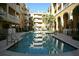 Inviting community pool surrounded by lush landscaping and beautiful architecture at 860 N Orange Ave # 318, Orlando, FL 32801