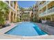 Relaxing community pool surrounded by lounge chairs and tropical landscaping at 860 N Orange Ave # 318, Orlando, FL 32801