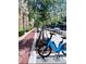 A bright blue Bird bike parked on a sidewalk near a brick-paved walking path at 860 N Orange Ave # 318, Orlando, FL 32801