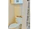 Close-up of toilet with decorative candle display on the tank and coordinating towel at 860 N Orange Ave # 318, Orlando, FL 32801