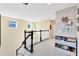 Upstairs hallway featuring white shelving storage and a view of the staircase with black and white banister at 8743 Sidley Ln, Orlando, FL 32832