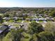 This aerial view highlights the neighborhood's mature trees, well-kept lawns, and unique homes at 919 Timor Ave, Orlando, FL 32804