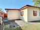 Backyard featuring a concrete patio and a view of the tan-colored house at 919 Timor Ave, Orlando, FL 32804