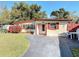 Attractive single-story home with a well-kept lawn, red shutters and accents at 919 Timor Ave, Orlando, FL 32804