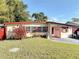 Charming single-story home with a well-maintained lawn and red trim and shutters at 919 Timor Ave, Orlando, FL 32804