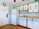 Cozy kitchen featuring a refrigerator, ample cabinet space, and unique wallpaper at 919 Timor Ave, Orlando, FL 32804
