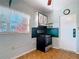 Retro kitchen with floral wallpaper, decorative cabinets, and black stove at 919 Timor Ave, Orlando, FL 32804