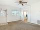 Living room featuring a door with stained-glass window, a ceiling fan, and a view to the kitchen at 919 Timor Ave, Orlando, FL 32804