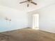 Spacious living room with neutral-toned walls, carpeting, and ceiling fan at 919 Timor Ave, Orlando, FL 32804