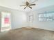 Comfortable living room featuring a unique door, a ceiling fan, and a window at 919 Timor Ave, Orlando, FL 32804