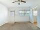 Neutral-toned living room featuring carpeting, a door, a window and a view to the kitchen at 919 Timor Ave, Orlando, FL 32804