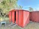 Backyard with a red storage shed and some grass at 919 Timor Ave, Orlando, FL 32804