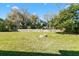 Large backyard with green grass and a fire pit at 925 Valleydale Ave, Deland, FL 32720