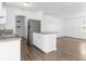 Well-lit kitchen with white cabinets, granite countertops, and a stainless steel refrigerator at 925 Valleydale Ave, Deland, FL 32720