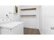 Functional laundry room with shelving, modern washer, and updated flooring at 925 Valleydale Ave, Deland, FL 32720