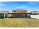 Large, grassy backyard features an enclosed patio at 10033 Hidden Dunes Ln, Orlando, FL 32832