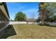 Large backyard with green grass and a white picket fence at 10033 Hidden Dunes Ln, Orlando, FL 32832