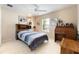 Well-lit bedroom featuring neutral walls, carpet floors, and a decorative headboard with side lamps at 10033 Hidden Dunes Ln, Orlando, FL 32832