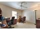 Comfortable bedroom with two desks, carpet floors, ceiling fan, and a closet at 10033 Hidden Dunes Ln, Orlando, FL 32832