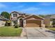 Two-story home featuring a large driveway and a well-manicured lawn at 10033 Hidden Dunes Ln, Orlando, FL 32832