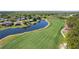 Picturesque golf course featuring meticulously manicured greens, a tranquil pond, and lush trees, providing a serene and challenging play at 10033 Hidden Dunes Ln, Orlando, FL 32832
